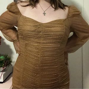 Gold, tan-ish dress, zip up. Just above knee length. Padding.